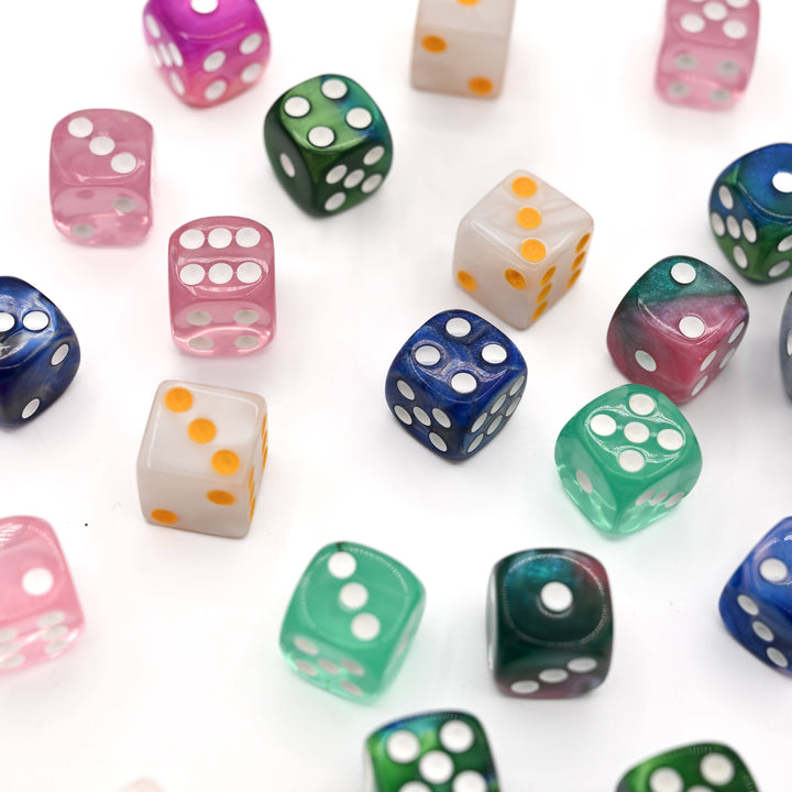 Assorted colored dice with white dots on a white background