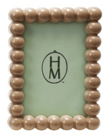 Beaded picture frame with 'HM' logo on a light green background