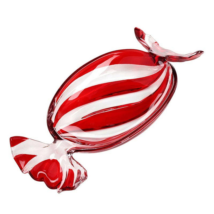 A red and white striped glass candy-shaped tray or decorative object with a wrapped tail, shown on a plain white background.