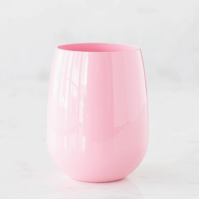 Pink ceramic cup on a light gray background