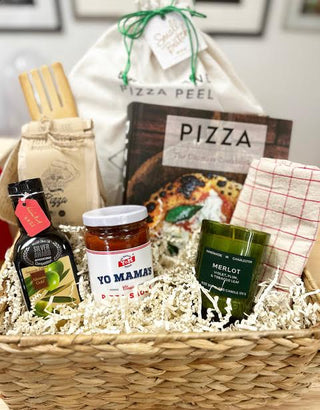 This hamper is filled with pizza essentials for making your own pies at home! Included is pizza dough and spices, olive oil, pizza sauce, pizza cookbook, pizza peel, Merlot-scented candle, a wooden mixing spoon and kitchen towel. So much fun to give and to receive! 