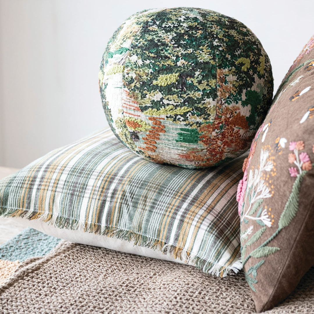 Decorative pillows with floral patterns on a textured surface