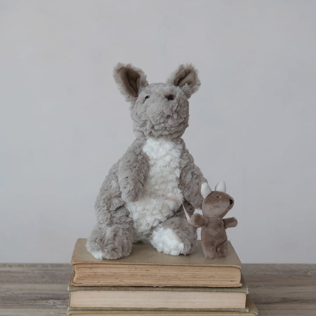 Stuffed animal on a stack of books with a plain background
