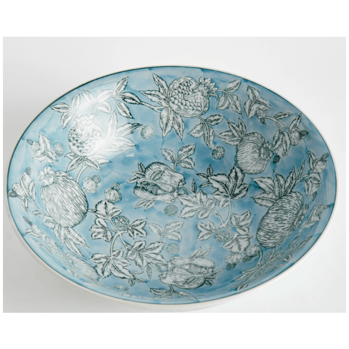 Decorative plate with floral and fruit pattern on a light blue background