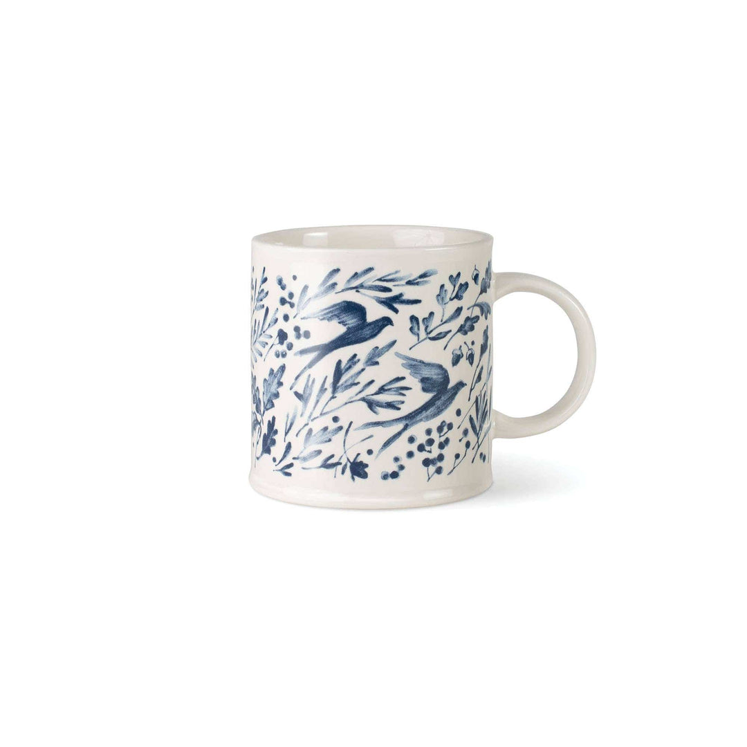 White mug with blue bird and leaf pattern on a white background
