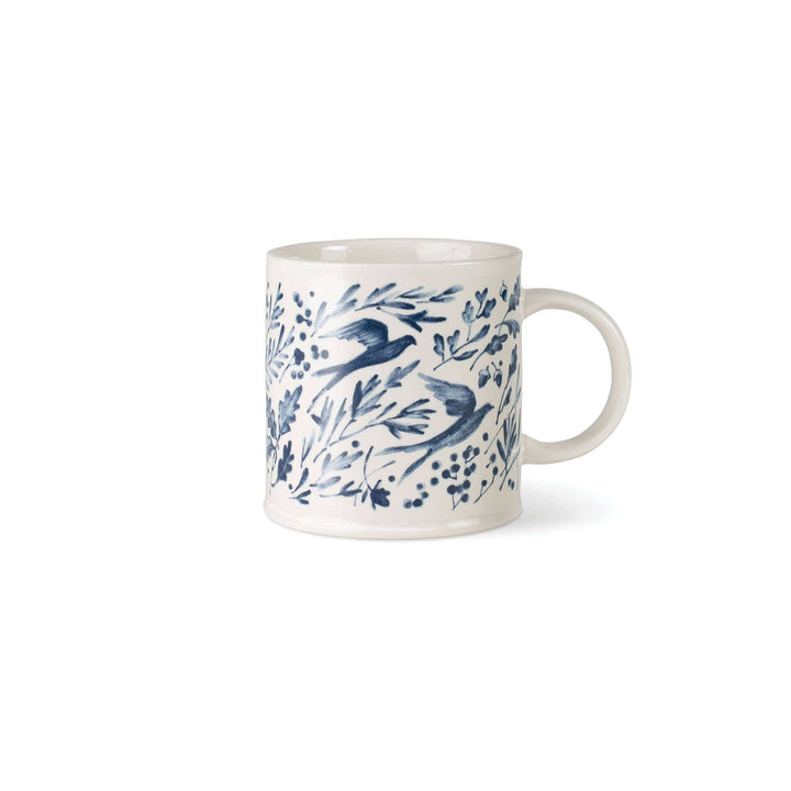 White mug with blue bird and leaf pattern on a white background