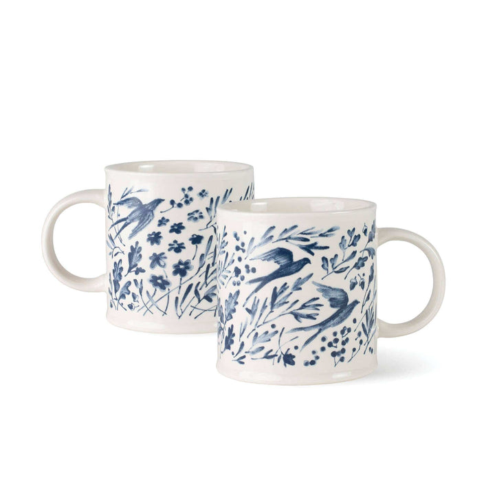 Two ceramic mugs with blue floral and bird pattern on a white background