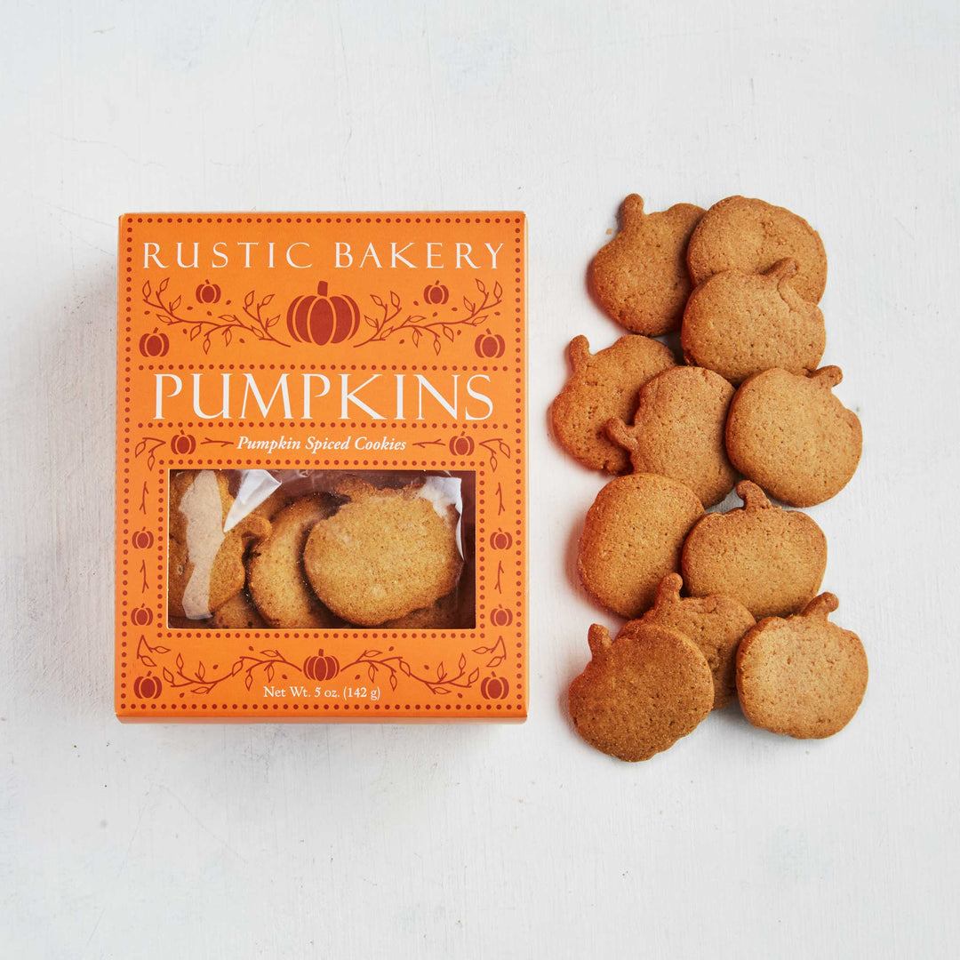 Rustic Bakery Pumpkin cookies displayed next to their orange pumpkin-themed packaging box on a white background.