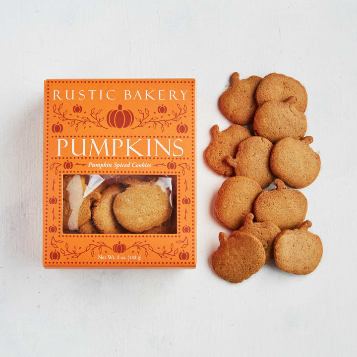 Rustic Bakery Pumpkin cookies displayed next to their orange pumpkin-themed packaging box on a white background.