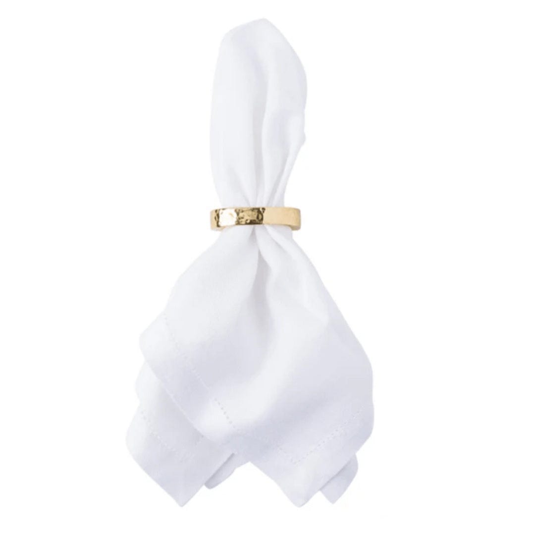 White napkin with a gold ring on a white background