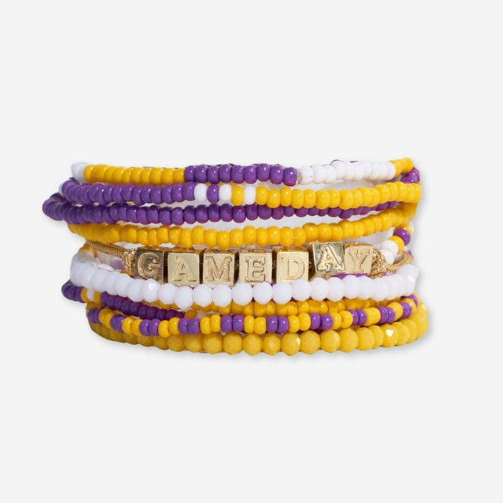 Stack of colorful beaded bracelets with 'GAMEDAY' charm on a white background