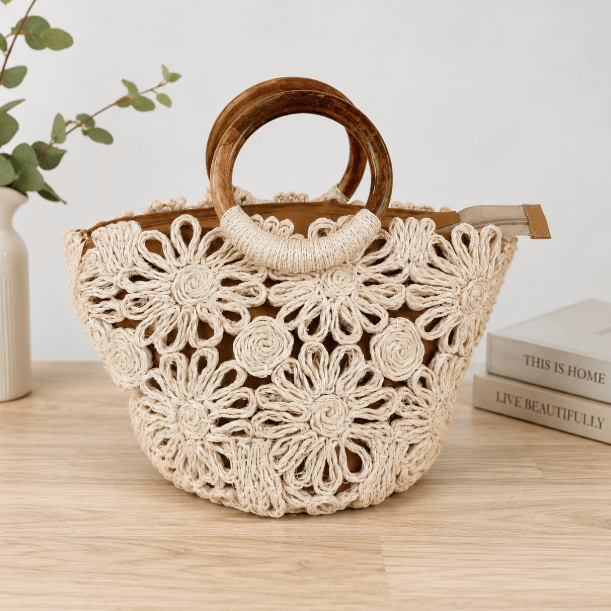 small woven floral tote bag with wooden handle on tabletop.
