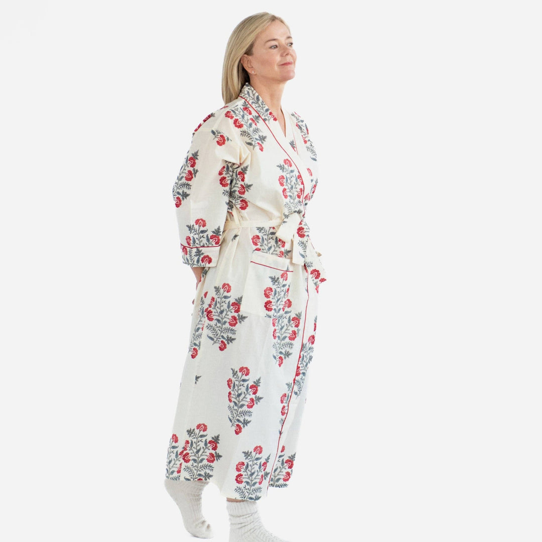 Woman wearing a floral robe on a white background