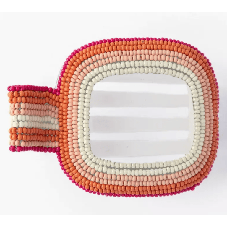 Beaded hair clip in pink, orange, and white on a white background