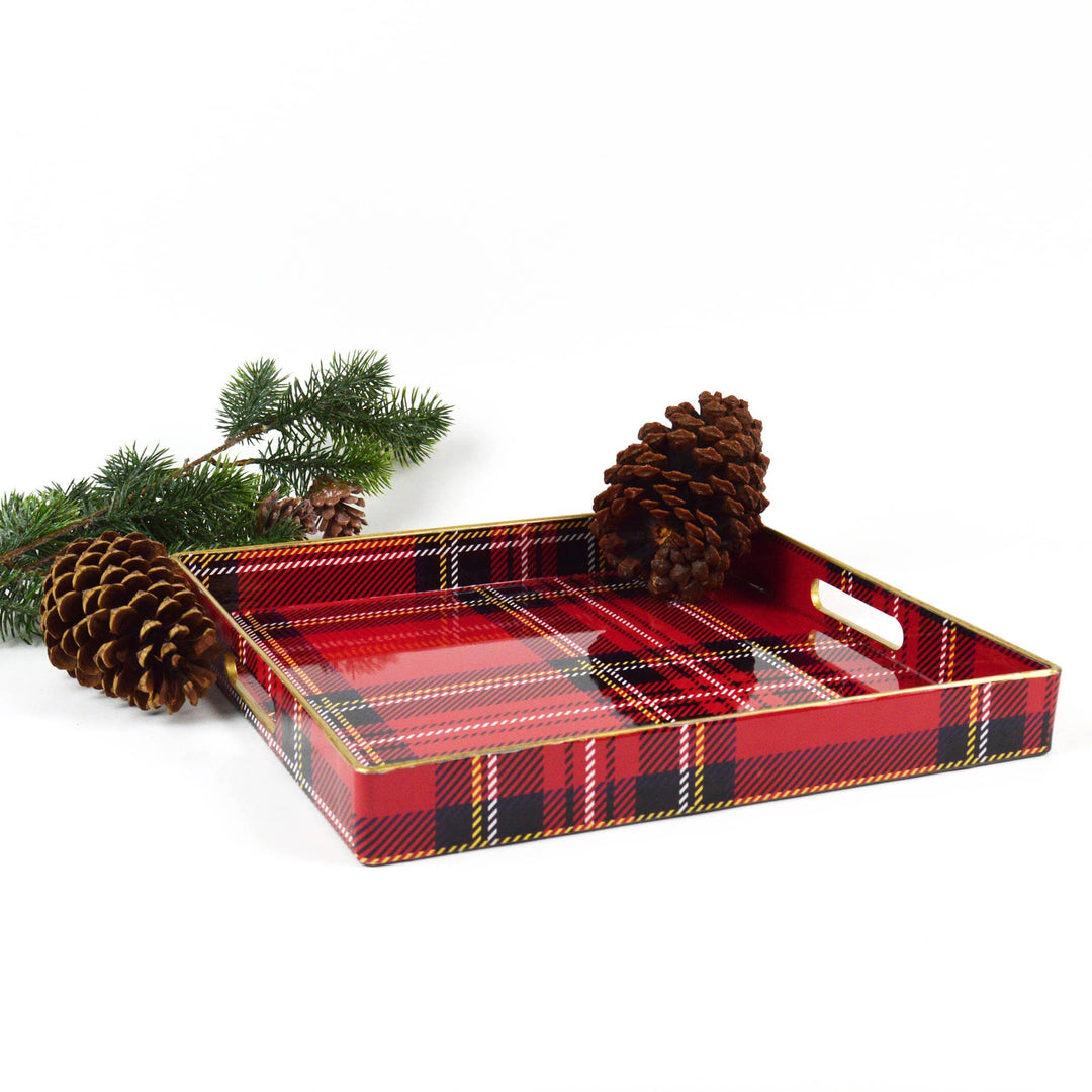 Red plaid tray with pine cones and branches on a white background