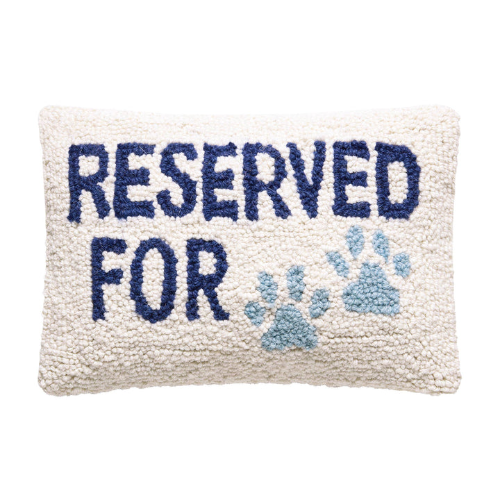 Decorative pillow with 'Reserved For' text and paw prints on a white background