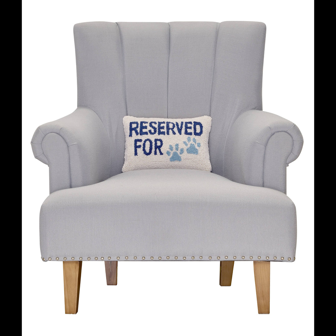 Gray armchair with a pillow that says 'Reserved for' on a white background