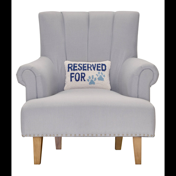 Gray armchair with a pillow that says 'Reserved for' on a white background