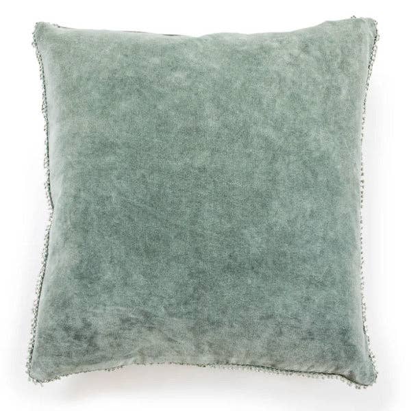 Green cushion with textured surface on a white background