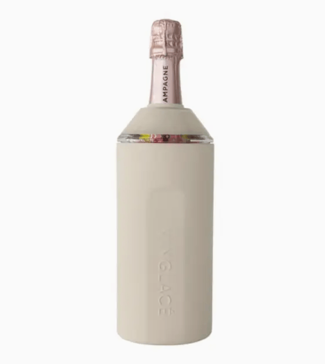 Bottle of champagne with a sand colored sleeve on a white background