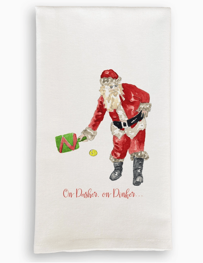 Tea towel with a festive design of Santa Claus holding a green bag and a yellow ball, with text 'On Dasher, on Dinker' on a white background.
