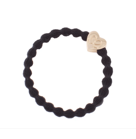 Black braided hair tie with a heart-shaped gold charm on a white background