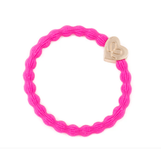 Pink bracelet with a heart-shaped gold charm on a white background