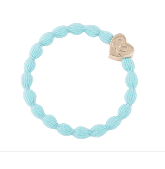 Light blue braided bracelet with a heart-shaped gold charm on a white background