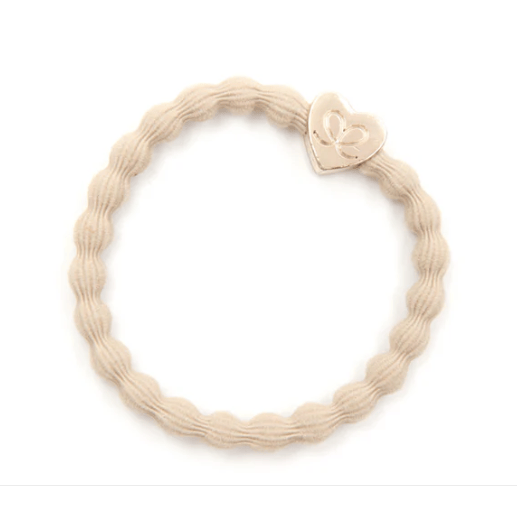 Beige woven bracelet with a heart-shaped clasp on a white background