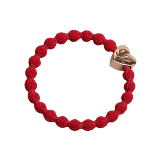 Red braided bracelet with a gold heart-shaped clasp on a white background