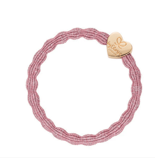 Pink beaded bracelet with a gold heart-shaped charm on a white background