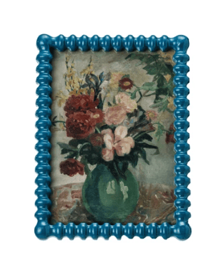 Decorative frame with a floral painting inside on a white background