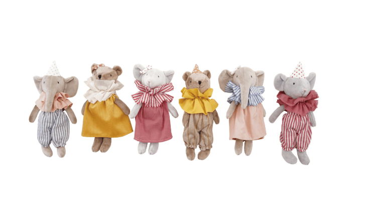 Set of small stuffed animals in colorful outfits on a white background