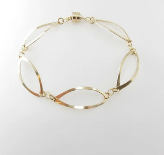 Bracelet of 5 forged 14K gold filled curved marquis links with magnetic clasp on white background.