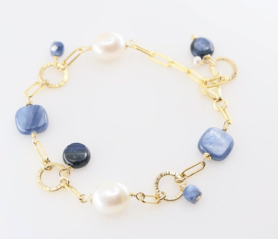 Bracelet with square blue kyanite stones and large rice pearls and gold filled hammered links on white background.
