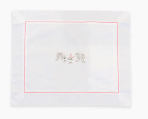White  lumbar pillowcase embroidered with sheep and pink border on a white background