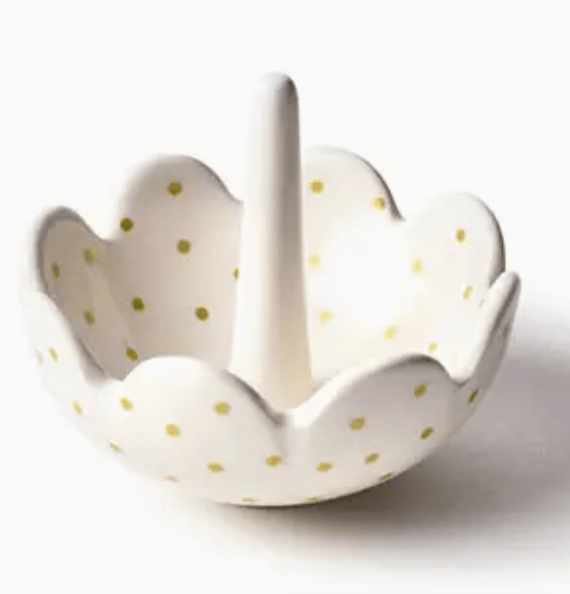 Scallop edge ceramic ring dish with gold polka dots on a white background