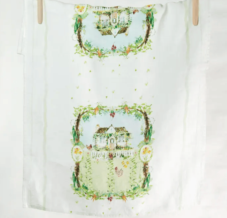 White towel with decorative house and garden design on a white background