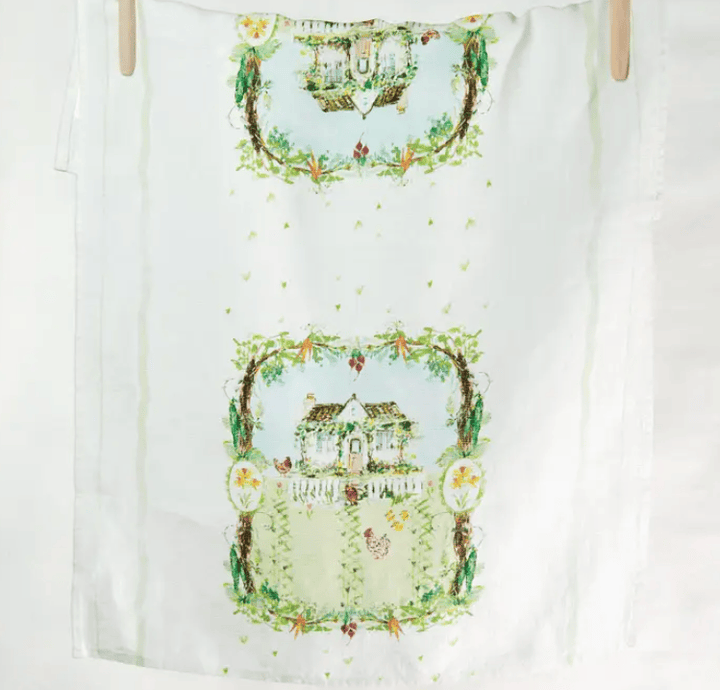 White towel with decorative house and garden design on a white background