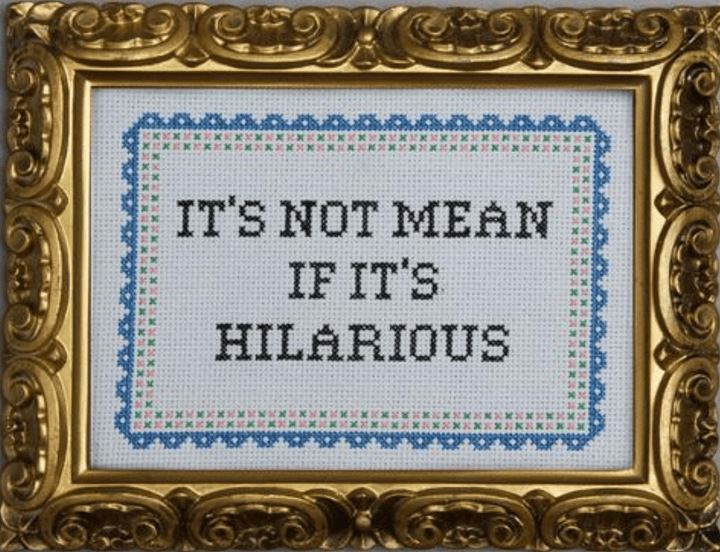 Decorative framed text with 'IT'S NOT MEAN IF IT'S HILARIOUS' in a gold frame.