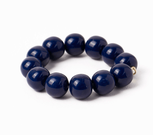 Navy blue beaded bracelet on a white background