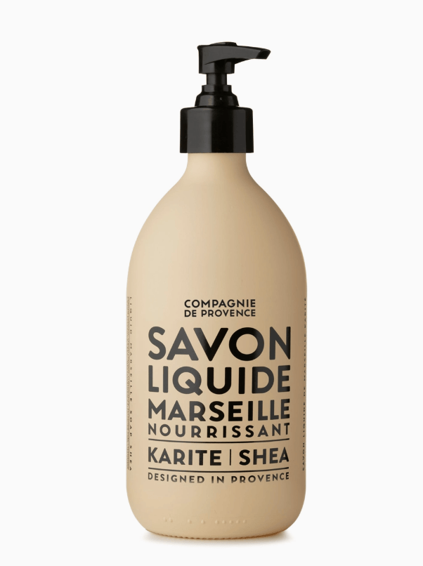 Beige bottle with black pump and text on a white background