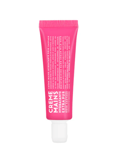 Pink tube of hand cream on a white background