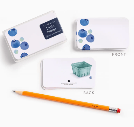 Note cards with blueberry design, pencil, and box on a white background