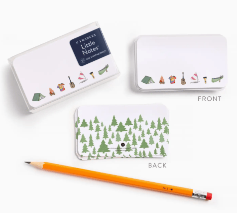 Notebook with tree pattern, pencil, and packaging on a white background
