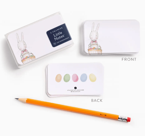 Notebook with rabbit design, colored dots, and a pencil on a white background