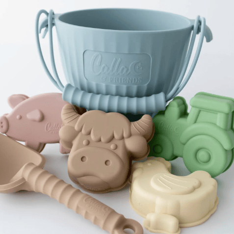 Set of colorful animal-shaped molds with a blue bucket on a white background