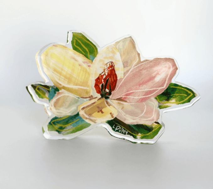 Decorative flower-shaped object with pink and yellow petals on a white background