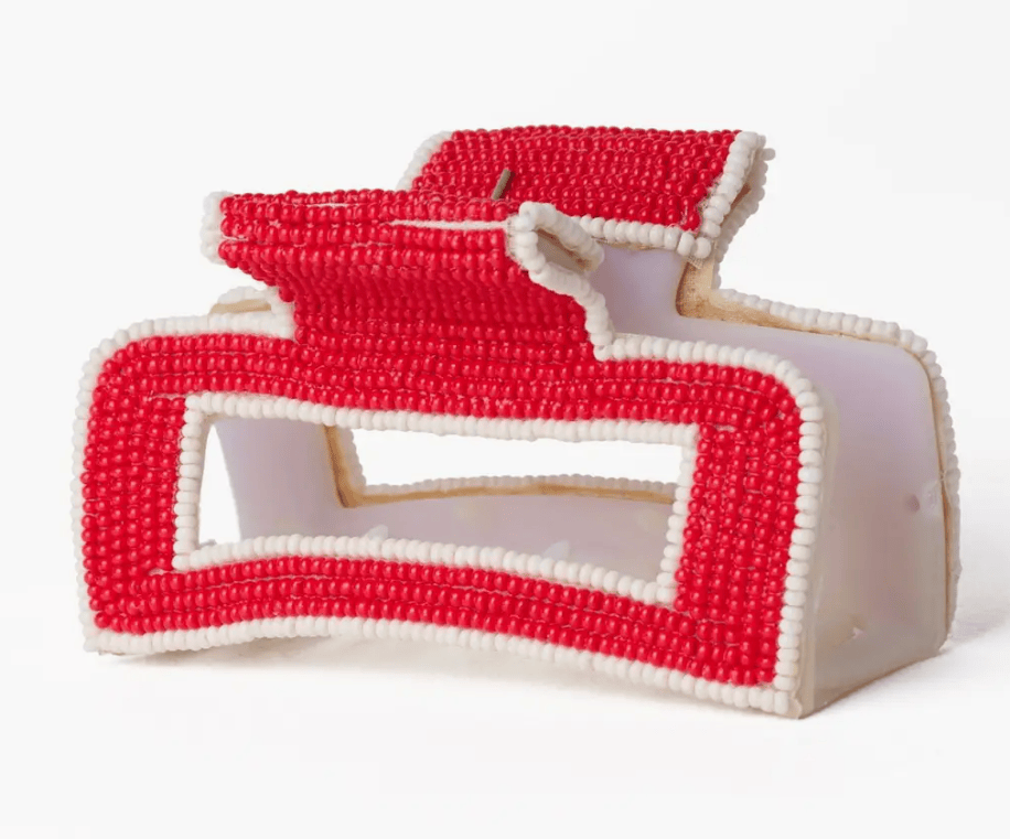Red and white beaded claw hair clip on a white background