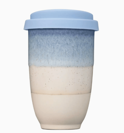 Two-tone ceramic cup with a light blue lid on a white background